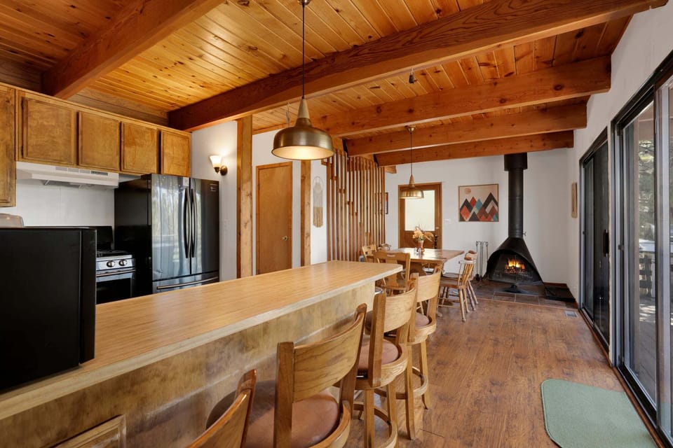 Fully equipped cabin kitchen with ample cabinetry, stove, fridge, microwave, and coffee maker—perfect for cooking meals, morning coffee, and feeling right at home on your stay.