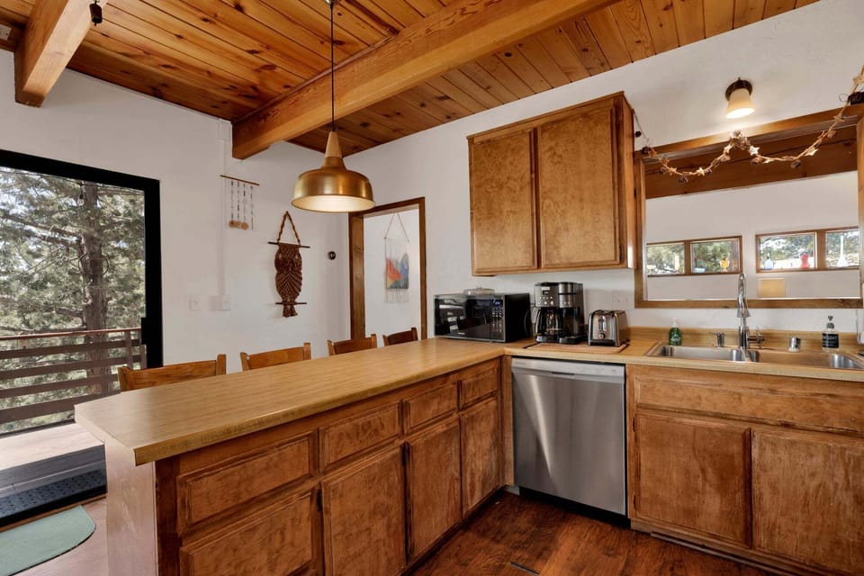 Fully equipped cabin kitchen with ample cabinetry, stove, fridge, microwave, and coffee maker—perfect for cooking meals, morning coffee, and feeling right at home on your stay.