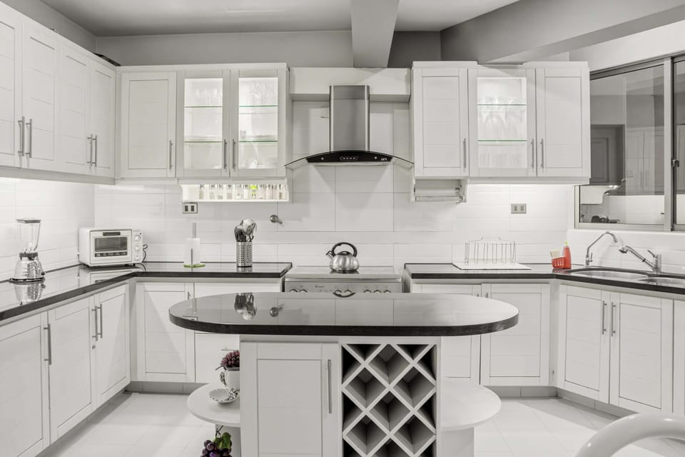 Full kitchen with microwave, hot water kettle, refrigerator, pantry, basic utensils and  foodware