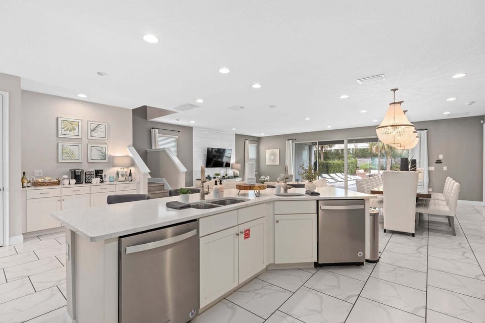 Kitchen area w/ large island and stainless-steel appliances