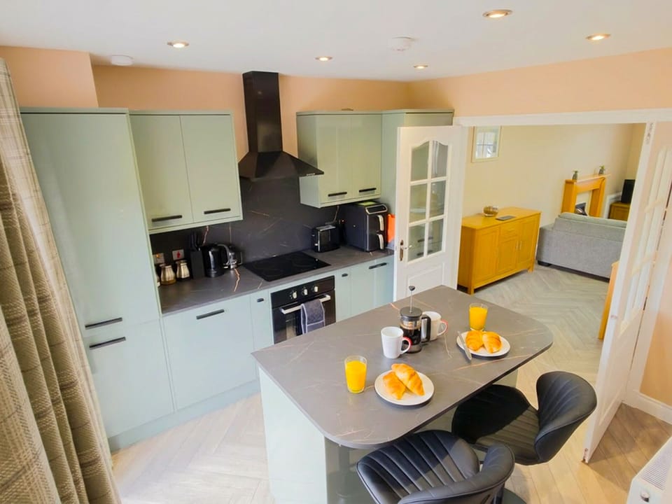 The heart of your holiday home awaits. This modern kitchen features everything you need, with a bright dining area perfect for enjoying meals together as a family.