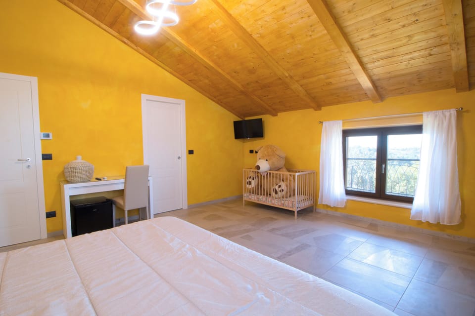 Comfort Quadruple Room, Courtyard View | Desk, laptop workspace, blackout drapes, soundproofing