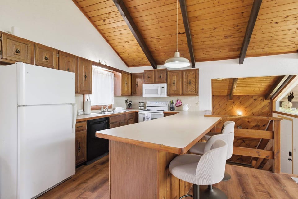 The oversized breakfast bar offers extra seating for snacks, drinks, and casual meals.