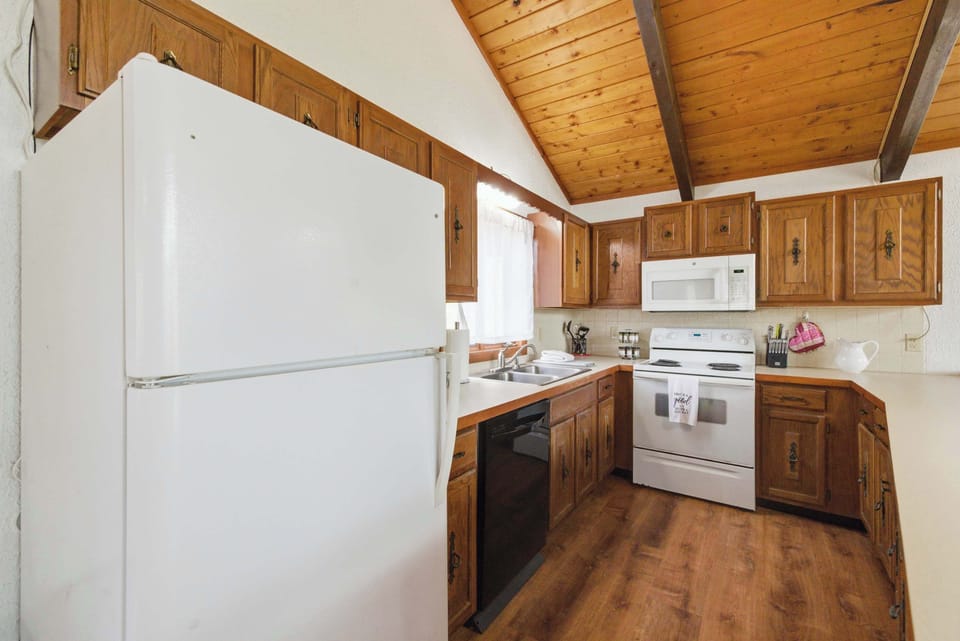 The fully equipped kitchen makes preparing family meals simple and convenient.