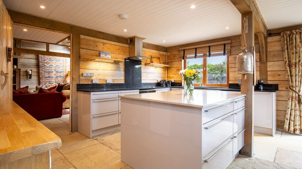 An stylishly practical space boasting a large kitchen island.