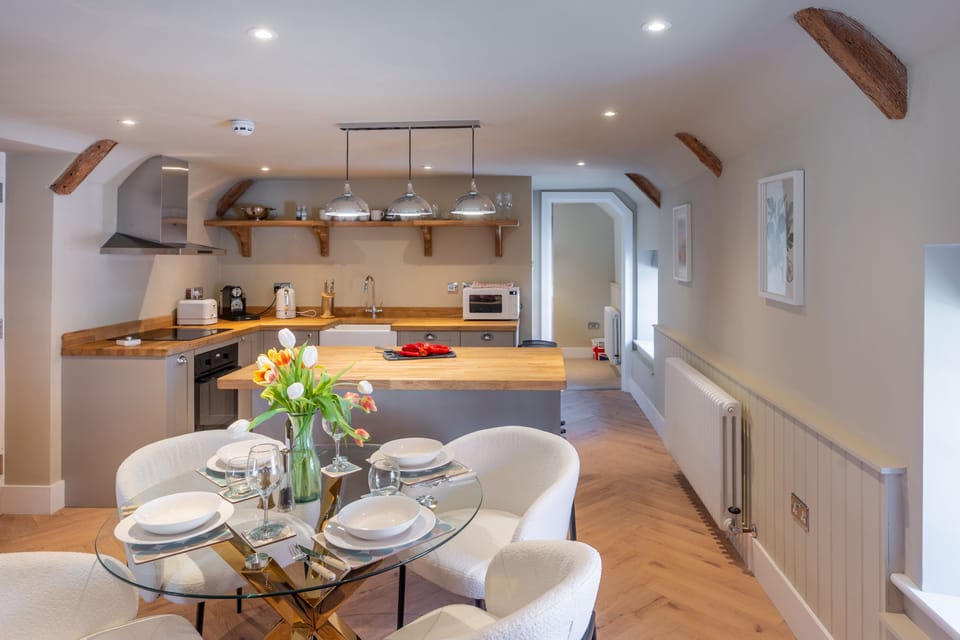 First floor: Living area is comprised of kitchen, dining table and sitting area with television
