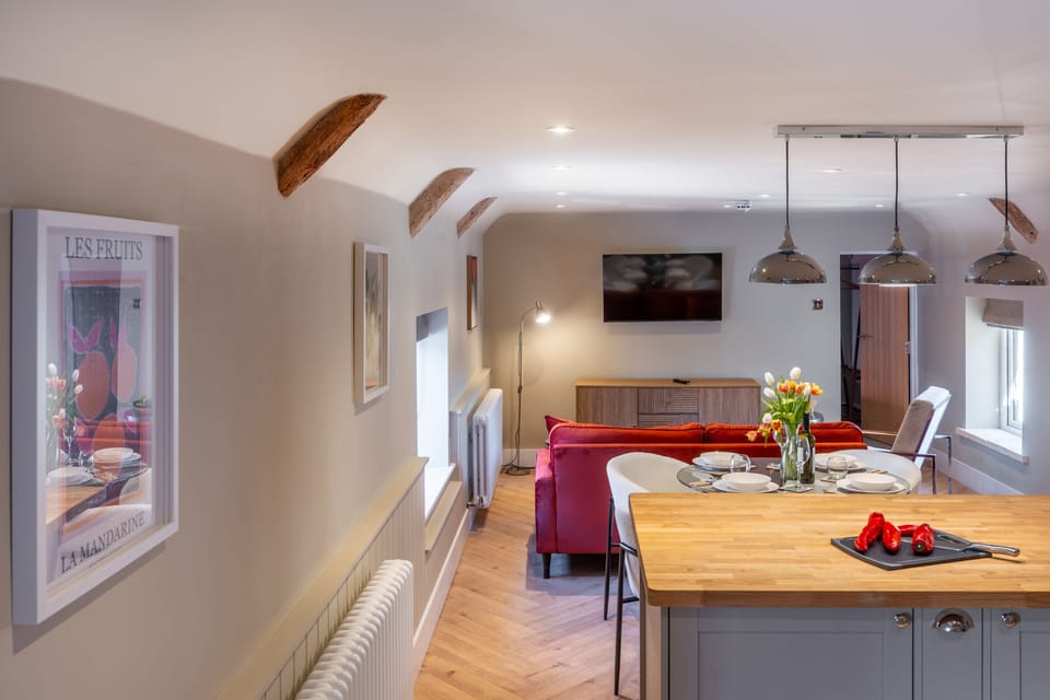 First floor: Living area is comprised of kitchen, dining table and sitting area with television