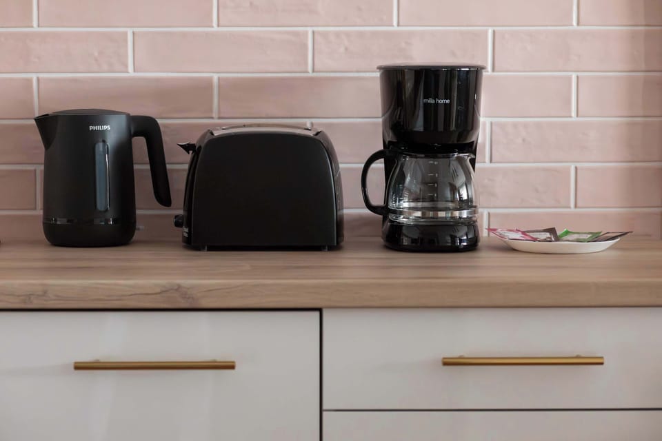 A kitchen counter with a coffee machine and appliances. It highlights convenience for daily use.