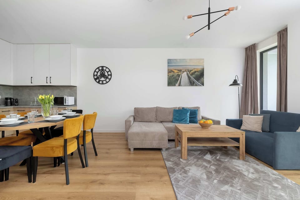 Spacious living room with dining table and modern kitchenette