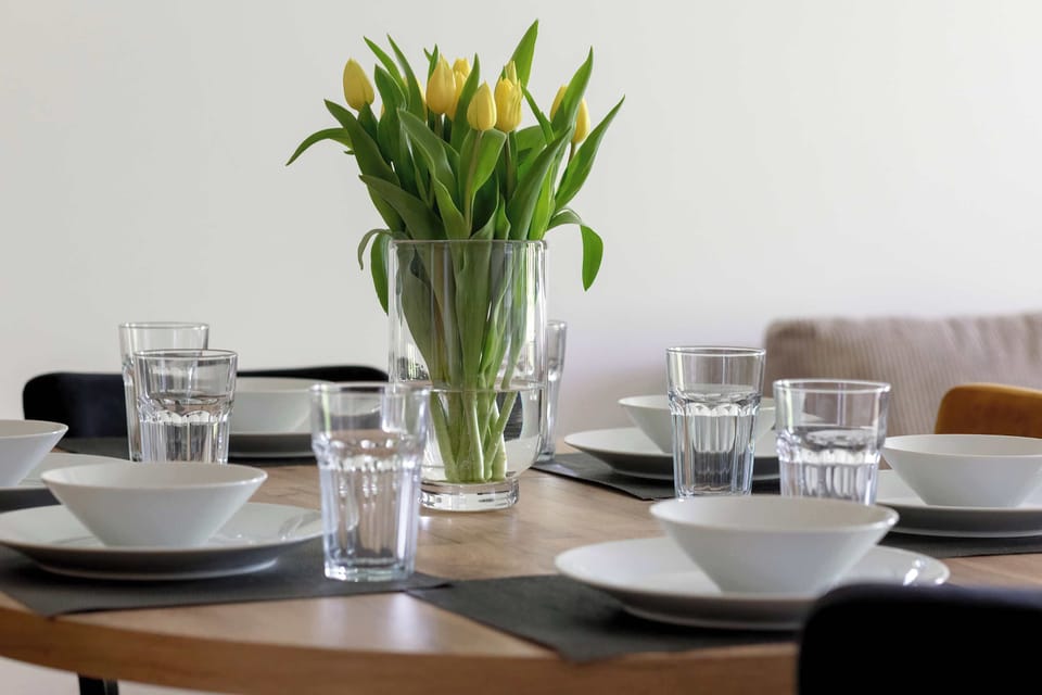Dining table setting with fresh tulips and elegant tableware