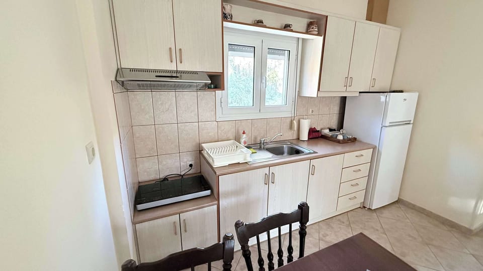 Fully equipped kitchen with everything needed for a comfortable stay, including cooking essentials, dining space, ideal for preparing meals with ease