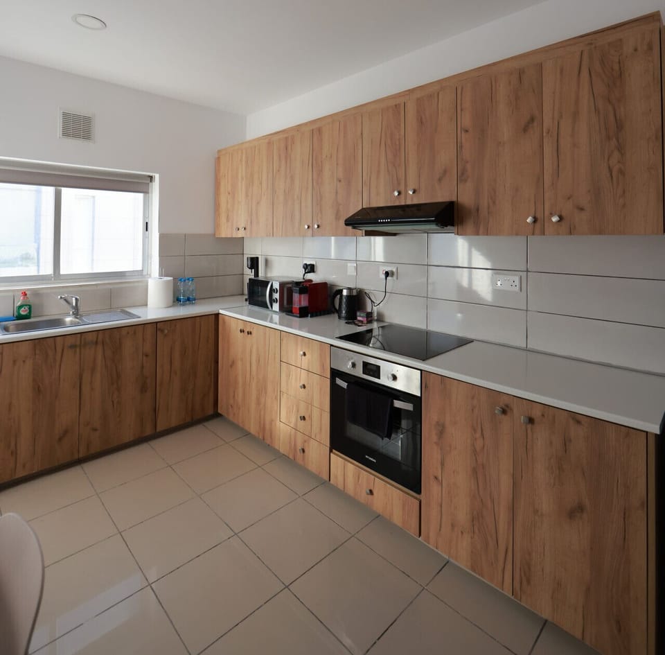 Bright and well-equipped kitchen perfect for cooking and enjoying home-style meals.