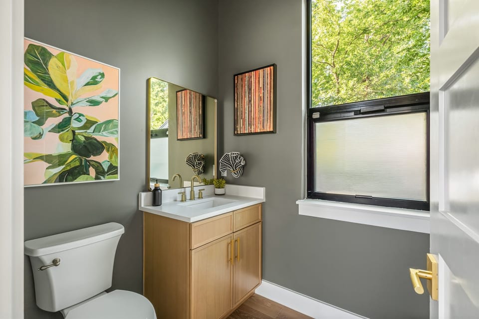 Chic and cozy half bathroom featuring modern décor, natural lighting, and stylish finishes that create a comfortable and welcoming space during your Austin getaway.