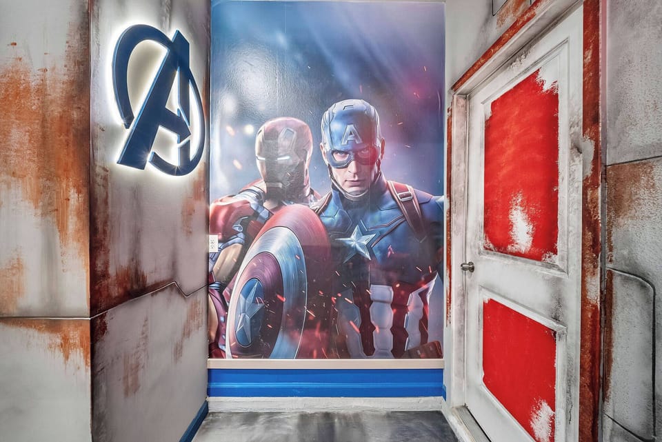 Welcome to a vibrant entryway adorned with a stunning mural of iconic superheroes, infusing the space with playful energy. The rustic textures and bold colors on the walls create a fun atmosphere that ignites excitement.