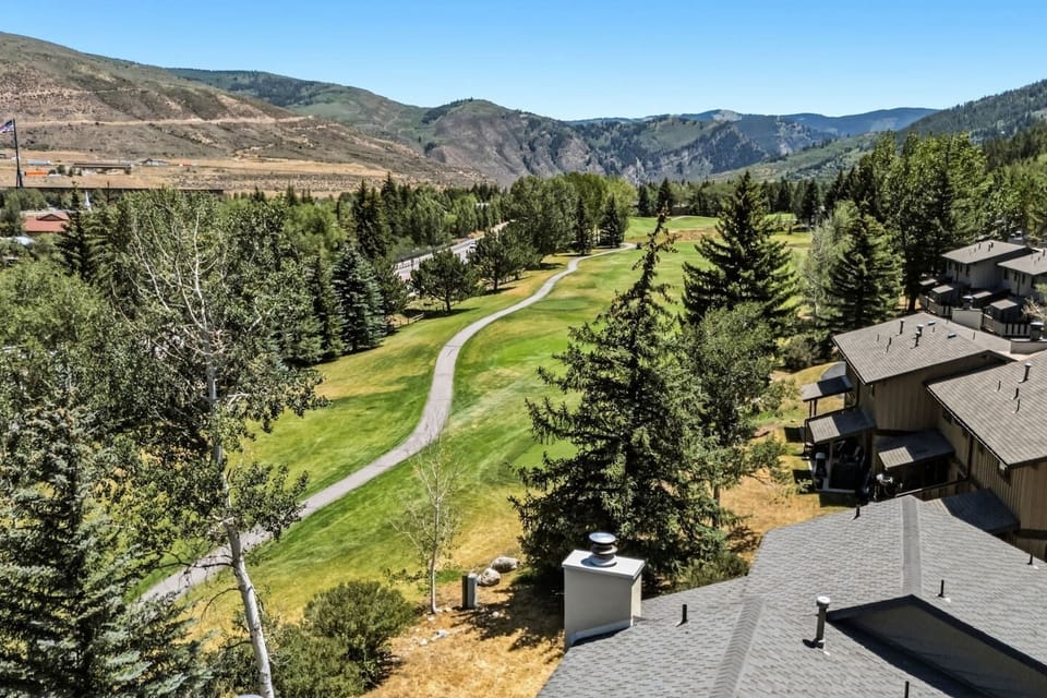 Nestled against a stunning backdrop of rolling hills and lush greenery, this charming multi-level residence offers the perfect blend of cozy mountain living and contemporary style.