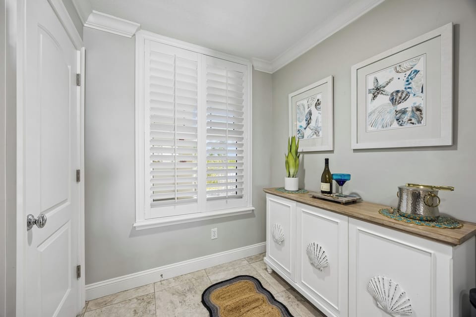 Step into your coastal retreat, where soft gray tones and charming seashell details create a welcoming beachside vibe. The warm wood countertop and natural light invite you to settle in and unwind.