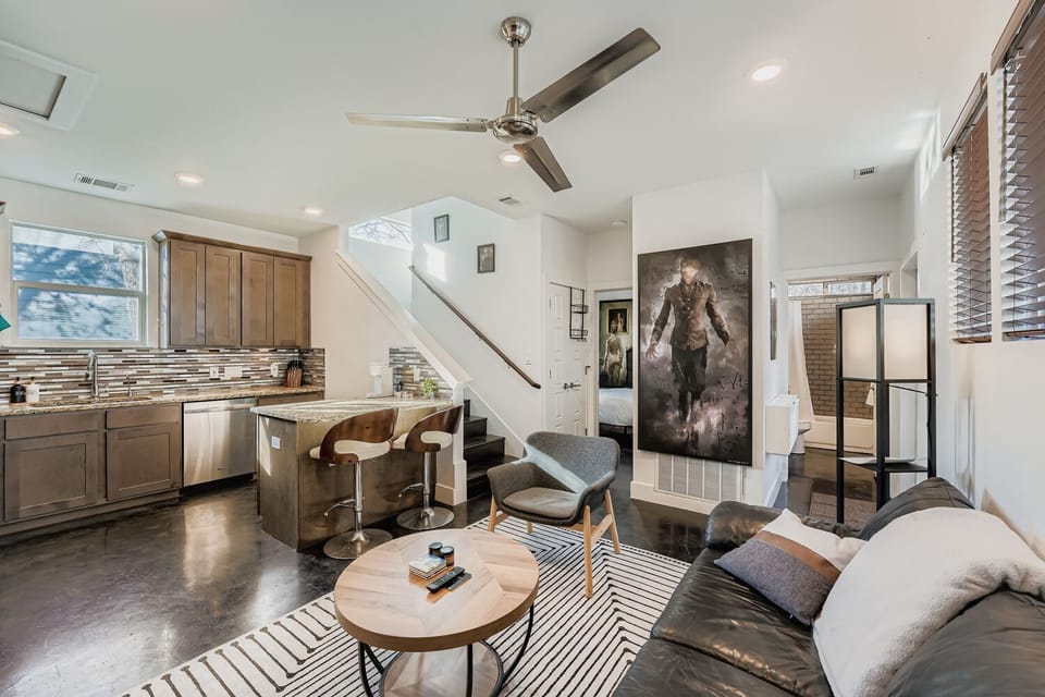 Bright living room with modern furnishings, open layout, and natural light.