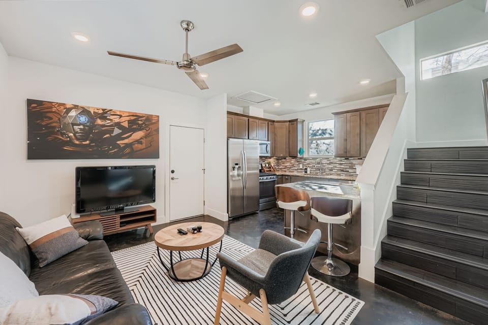 Stylish living room featuring contemporary décor and interior staircase.