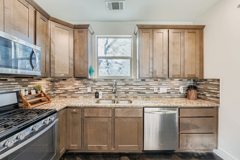 Fully equipped modern kitchen with stainless steel appliances and ample counter space.