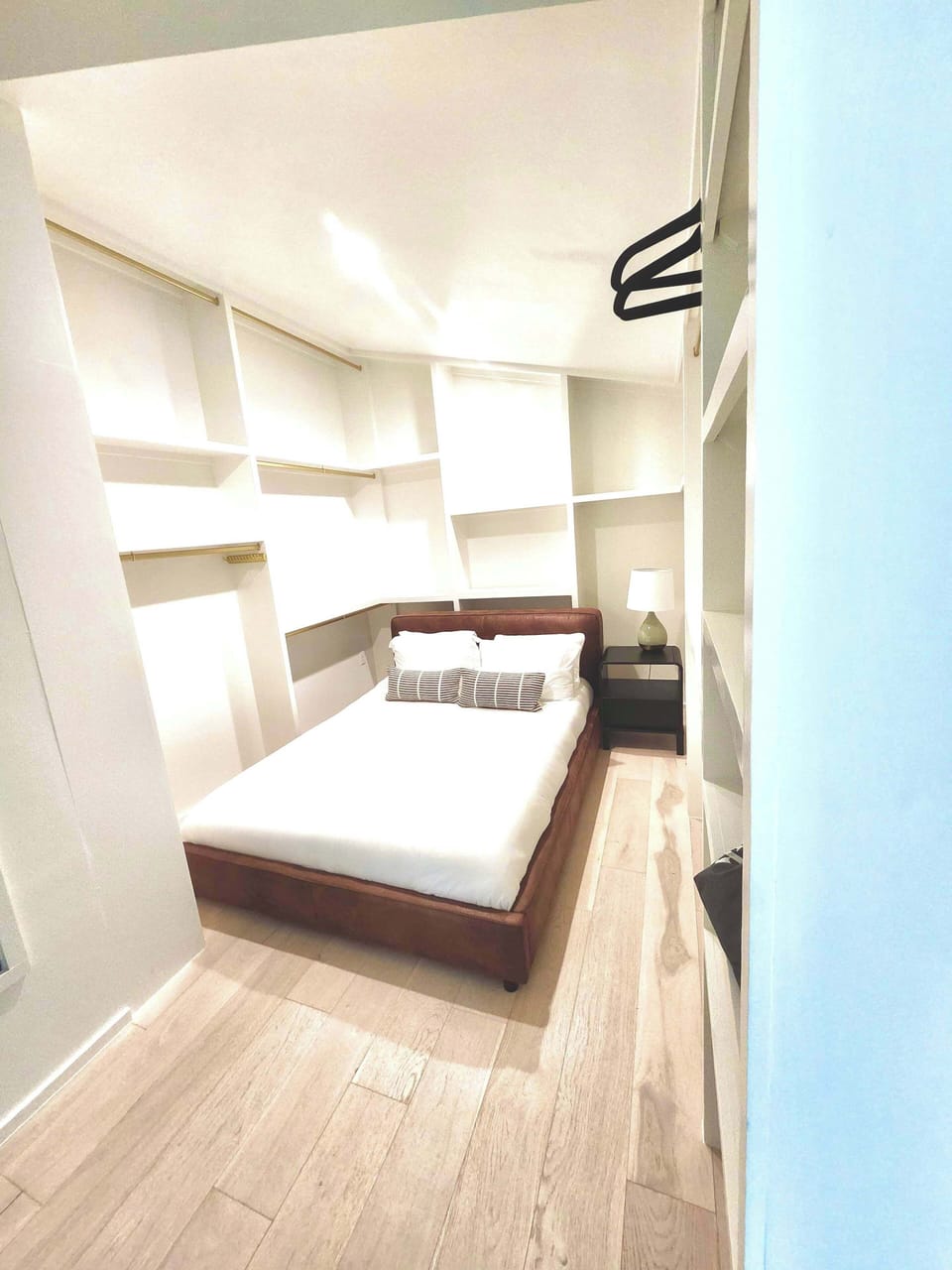 Large closet turned sleeping space. This room features a plush queen bed within the closet of the master bedroom. Has its own door for privacy and fan for white noise. 