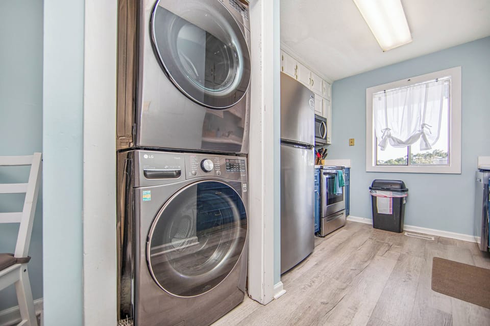 Bright kitchen with in-unit laundry and stainless steel appliances