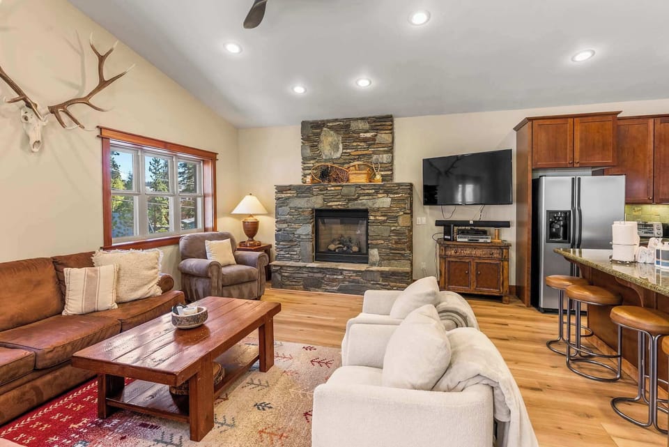 Open living room w/ fireplace & flat-screen TV