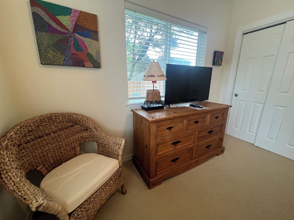 Bright natural light fills your room, where rustic wood furnishings meet coastal charm. Enjoy modern entertainment and eclectic art that adds character to your peaceful retreat.