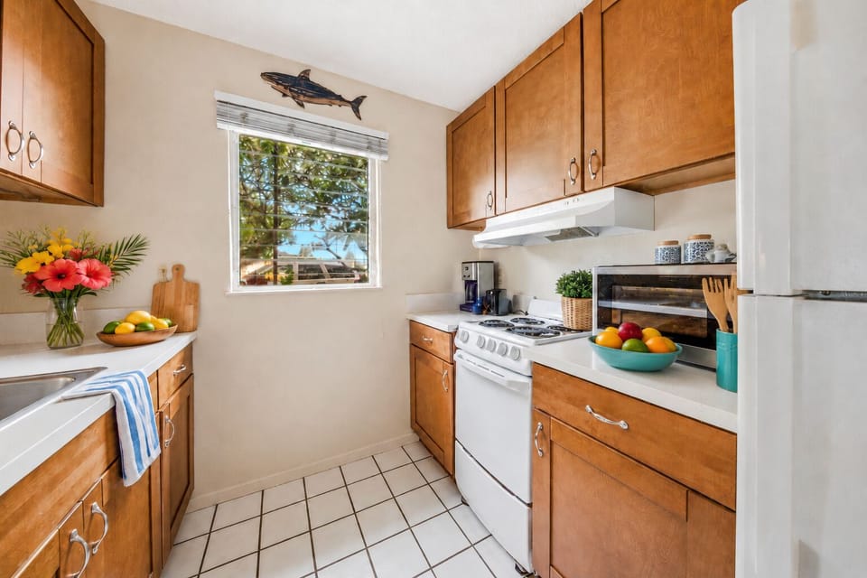 Bright blooms, tropical fruits, and a shark on the wall — cooking in paradise never looked so good.