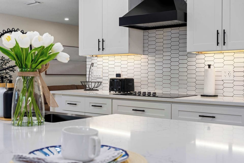 Start your mornings in this beautifully designed gourmet kitchen featuring sleek quartz countertops, modern finishes, and warm under-cabinet lighting. Perfect for coffee, cooking, and gathering with family and friends in style.