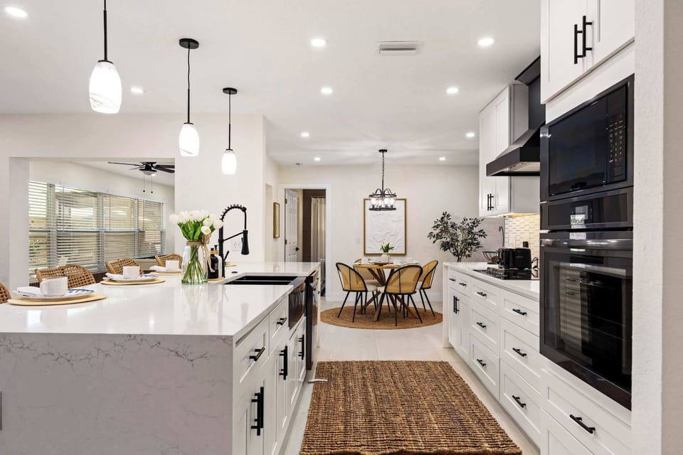 Cook and entertain with ease in this stunning modern kitchen featuring sleek quartz countertops, double ovens, spacious prep areas, and stylish lighting. The open layout flows perfectly for group gatherings, family meals, and relaxed vacation living.