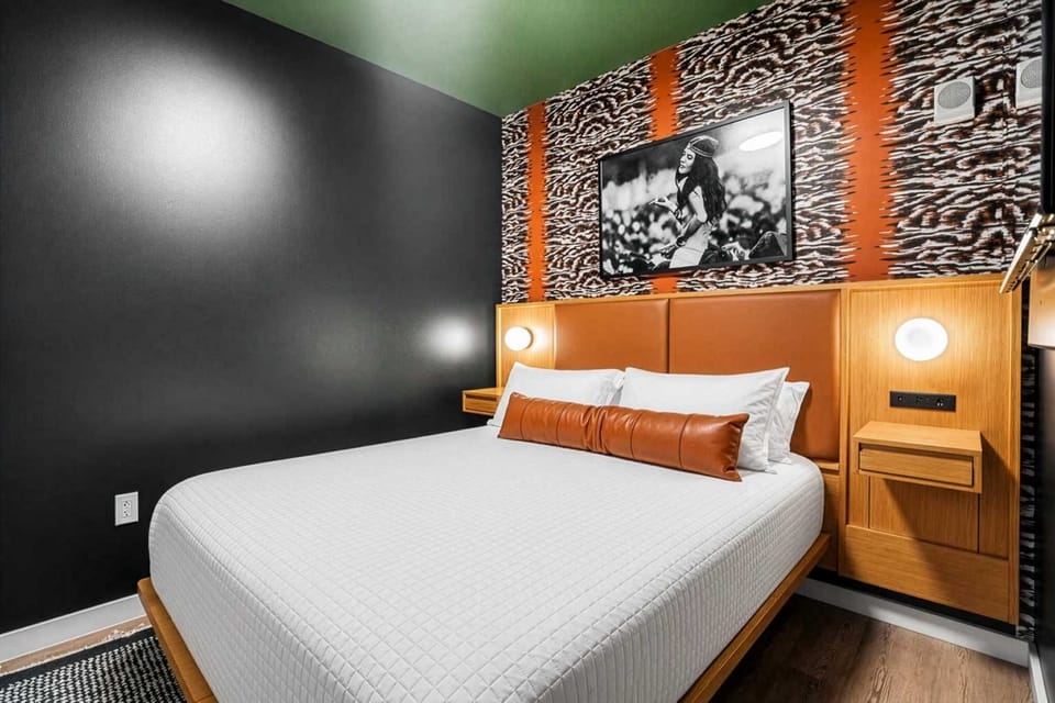 The 2nd bedroom stuns with bold tiger print walls, a queen bed, smart TV, closet space, and a shared Jack-and-Jill bath.
