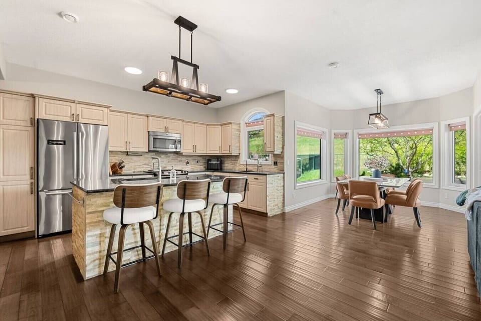 Expansive, full kitchen with a selection of coffee makers (drip, Keurig & french press), blender, crockpot/slow cooker, food processor, air fryer, reverse osmosis water tap and a gas stove. The kitchen is stocked with ground coffee, tea, sugar and basic c