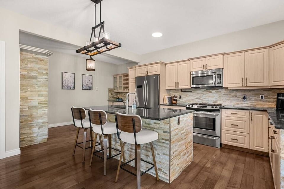Expansive, full kitchen with a selection of coffee makers (drip, Keurig & french press), blender, crockpot/slow cooker, food processor, air fryer, reverse osmosis water tap and a gas stove. The kitchen is stocked with ground coffee, tea, sugar and basic c