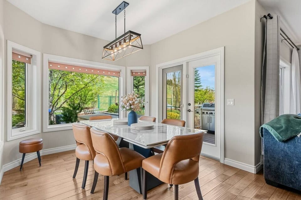 Dining area with seating for 8 at the table and 3 at the island.