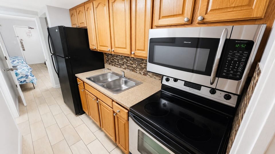 Prepare meals with ease in the fully equipped kitchen featuring a full-size stove, microwave, and refrigerator/freezer, along with everything you need for your stay. Start your mornings your way with both a traditional drip coffee maker and a Keurig-style