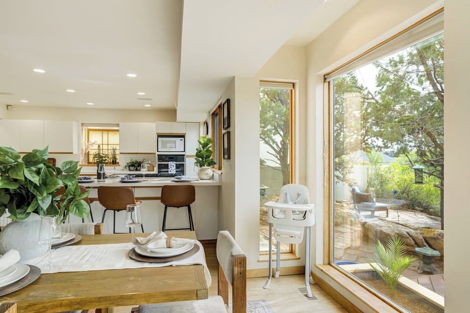 Just beside the kitchen, the large dining table offers plenty of room for shared dinners, game nights, or planning the next day's adventures.