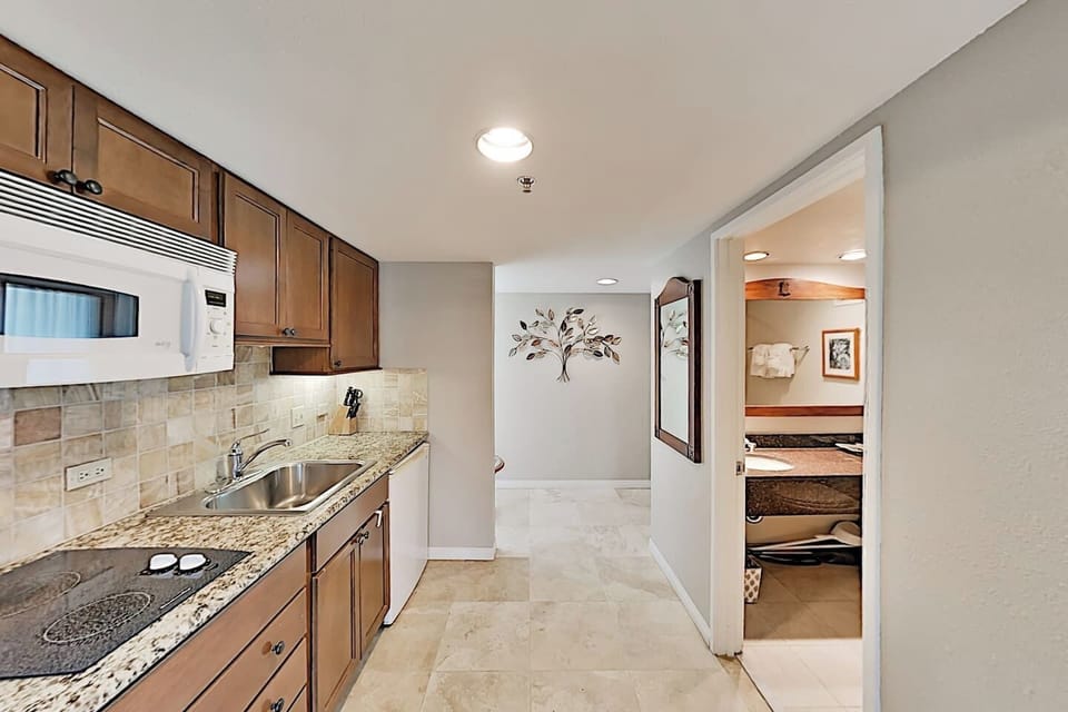 Kitchenette stocked with dishware, cutlery to prepare light meals