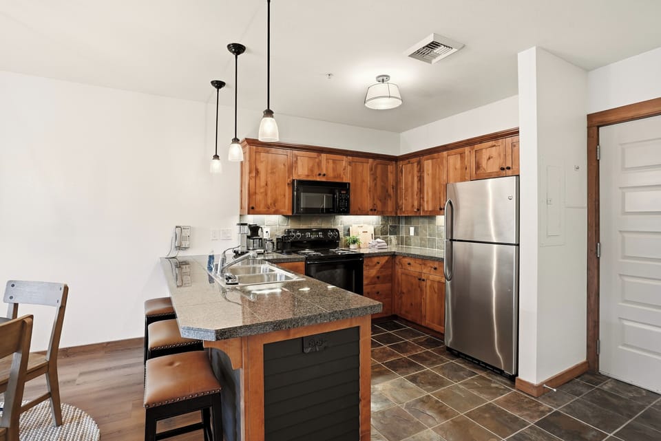 Bright rustic kitchen with granite island and stainless appliances