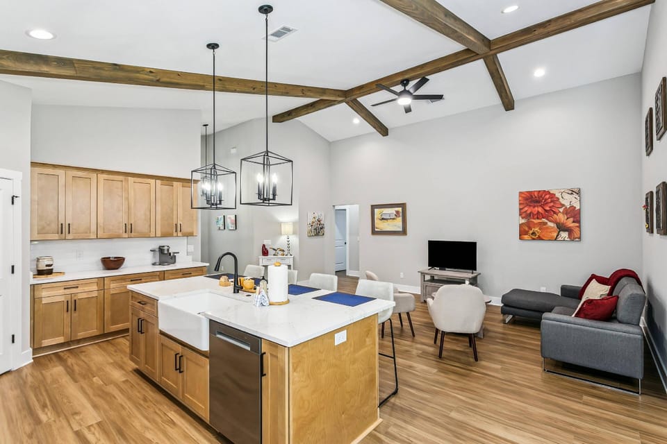 Large kitchen island with farmhouse sink and dishwasher