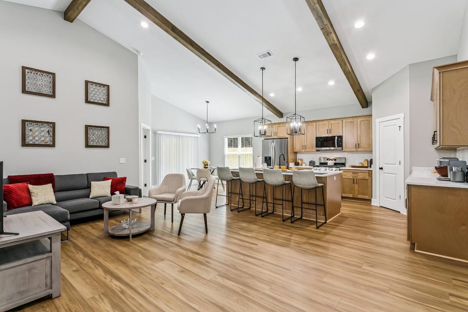 Open living, dining, and kitchen with hardwood floors throughout
