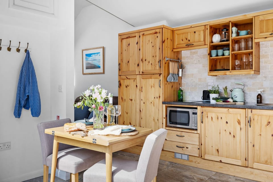 Coat hooks, dining table for two within kitchen - The Granary