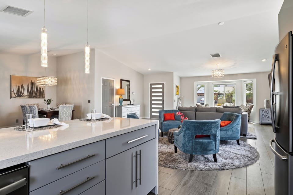 View from the kitchen island looking out into the dynamic living spaces, perfect for seamless indoor hosting.