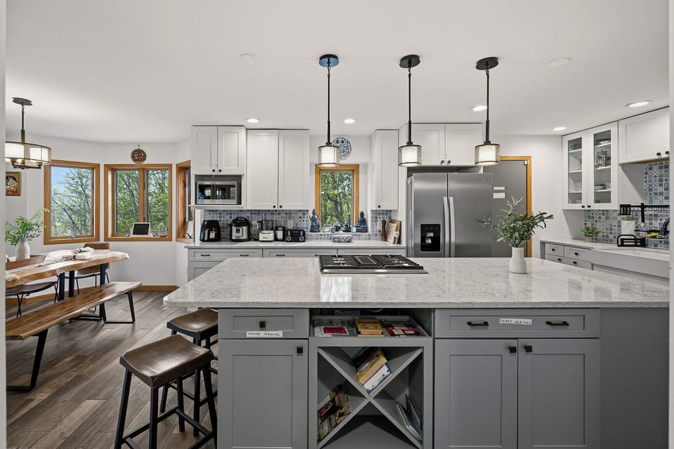 Modern kitchen with a spacious island, gas cooktop, and sleek finishes for easy group meals.