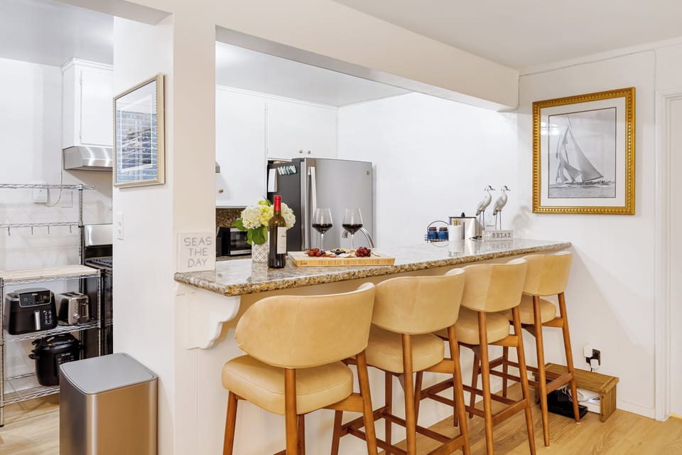 Gourmet kitchen featuring granite countertops, stainless steel appliances, and ample workspace.