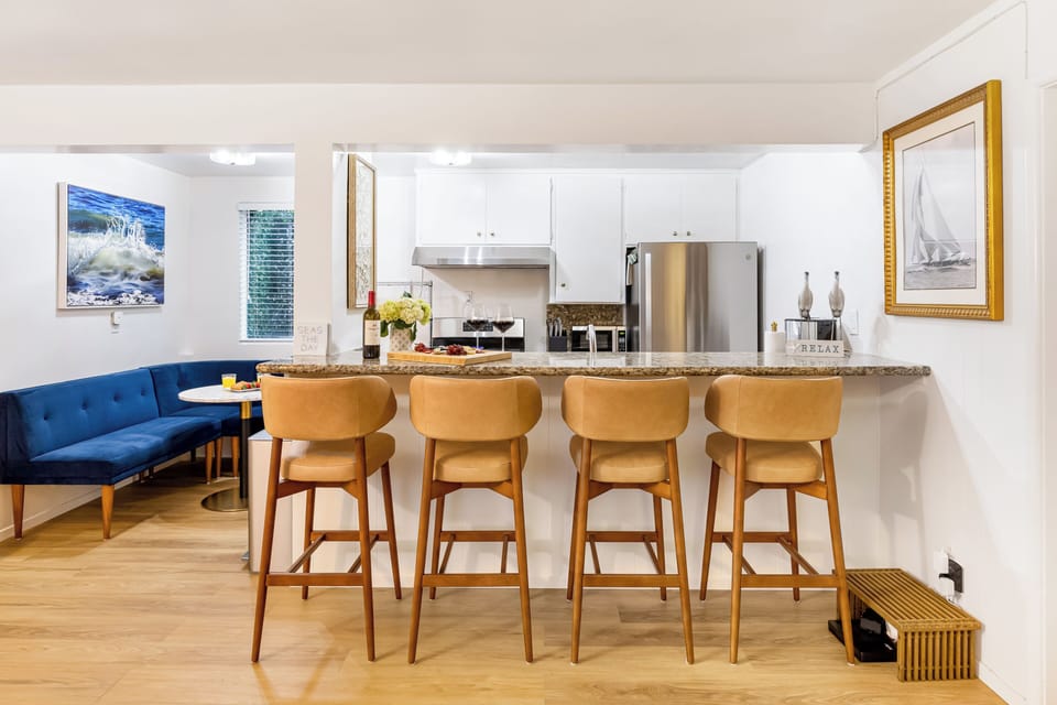 Large granite breakfast bar with seating for four—perfect for casual socializing while cooking.