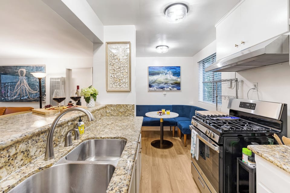 Fully equipped kitchen with a gas range and direct access to the cozy dining nook.