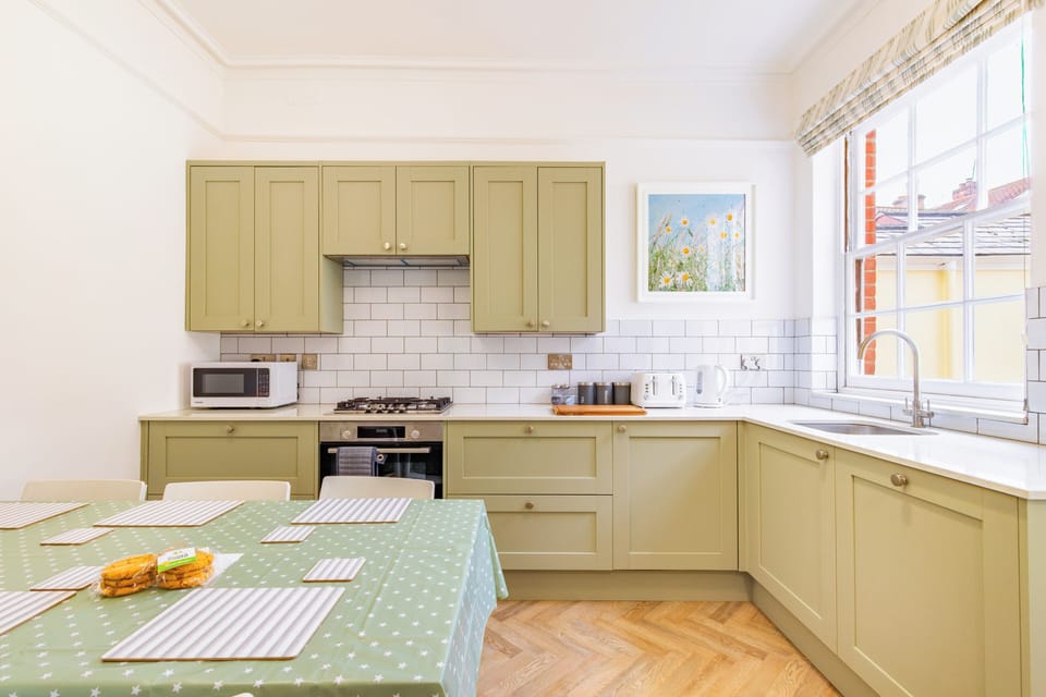 Fully equipped kitchen with dining table for seating. 