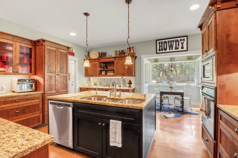 Your spacious country kitchen features granite countertops, warm wood cabinetry, and modern appliances where you'll love preparing home-cooked meals together.