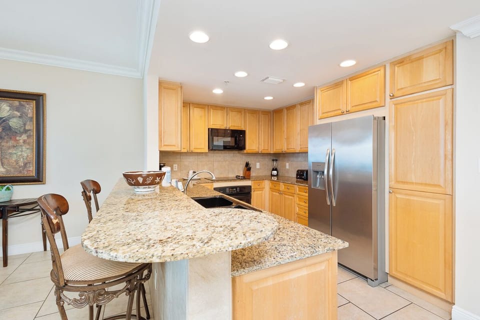 Prepare your favorite meals in this fully equipped kitchen with granite countertops, stainless steel appliances, and plenty of cabinet space—a comfortable spot for cooking and gathering.