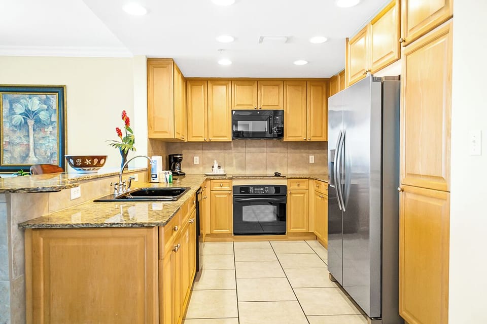 Your fully equipped kitchen invites you to prepare fresh meals with gleaming granite counters, modern appliances, and plenty of cabinet space for all your culinary needs.